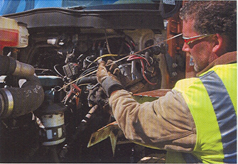 Checking the oil on the Nordic Waste 2006 International 7400 rear loading refuse hauler with a Navistar DT466 7.6L inline six cylinder diesel engine
